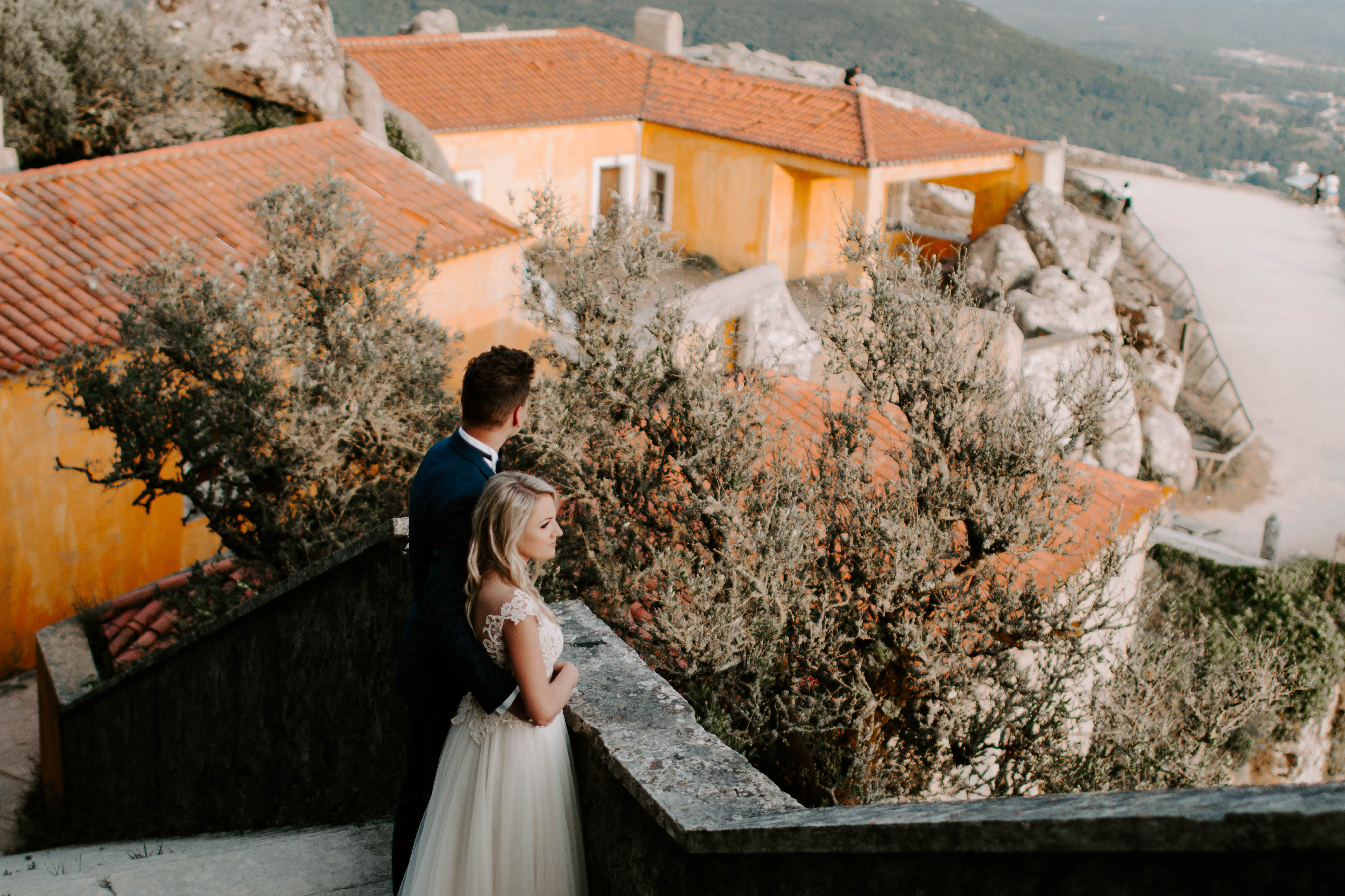 bride and groom standing in a castle
