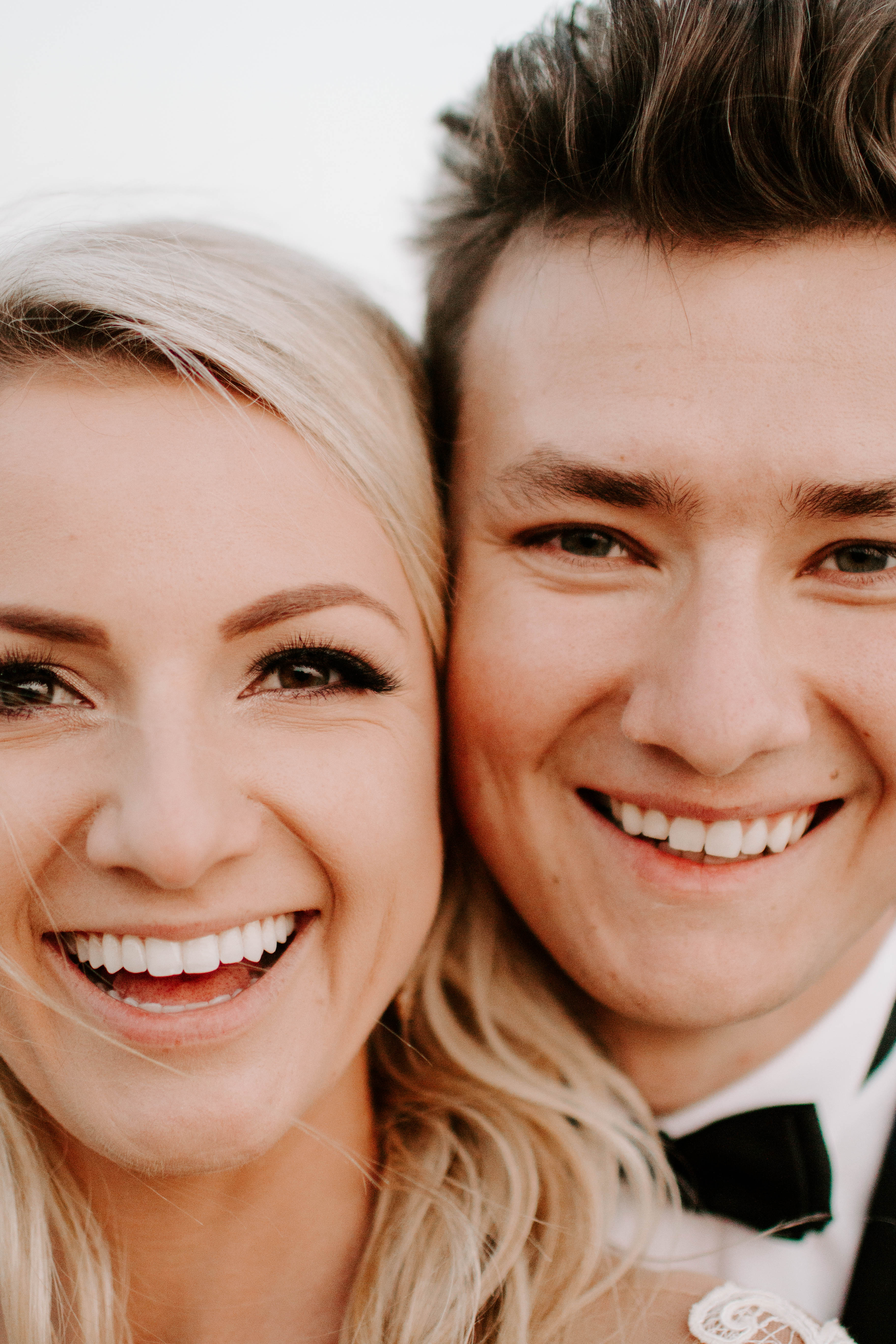 close up portrait of bride and groom laughing