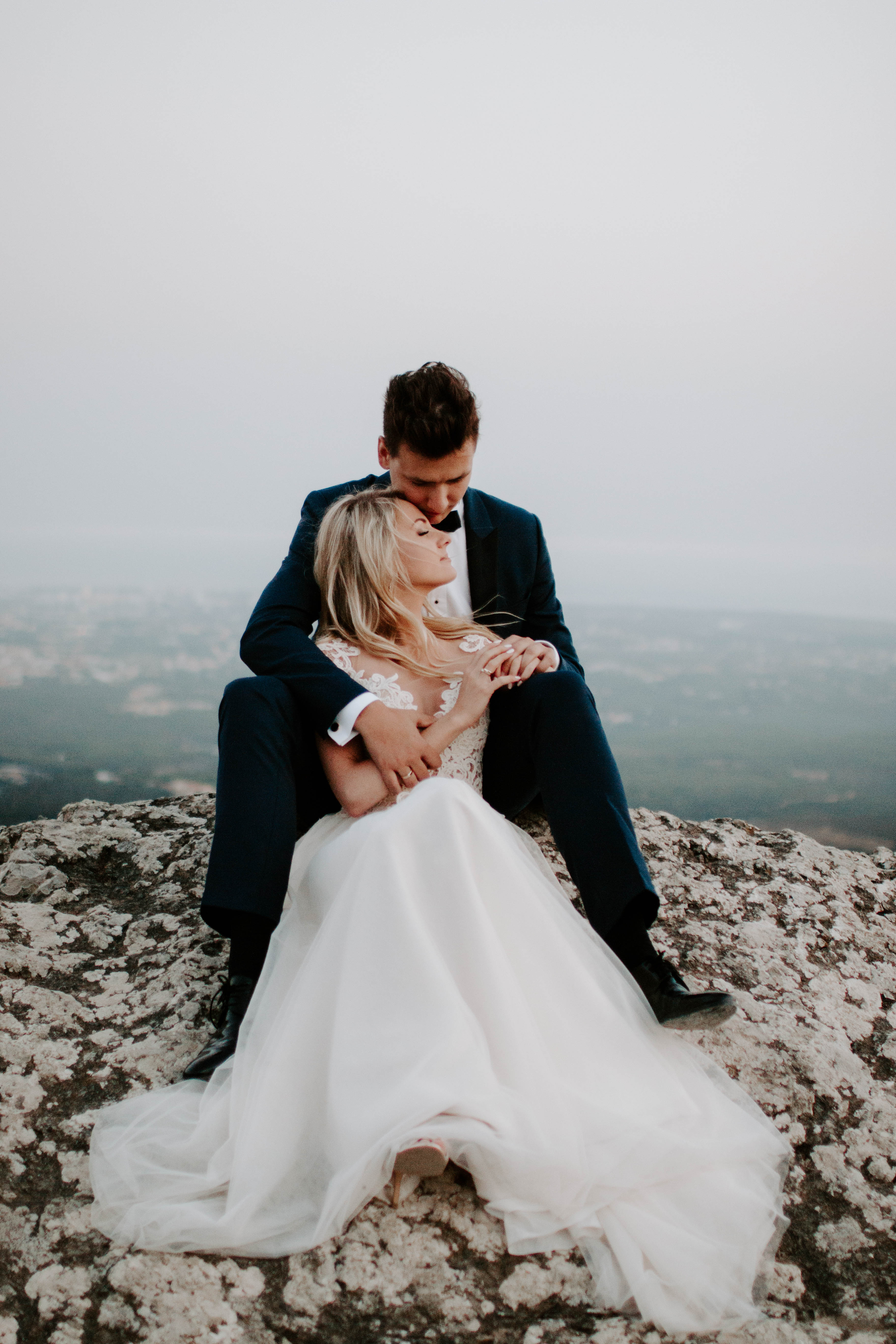 beautiful candid photo of a bride and groom hugging
