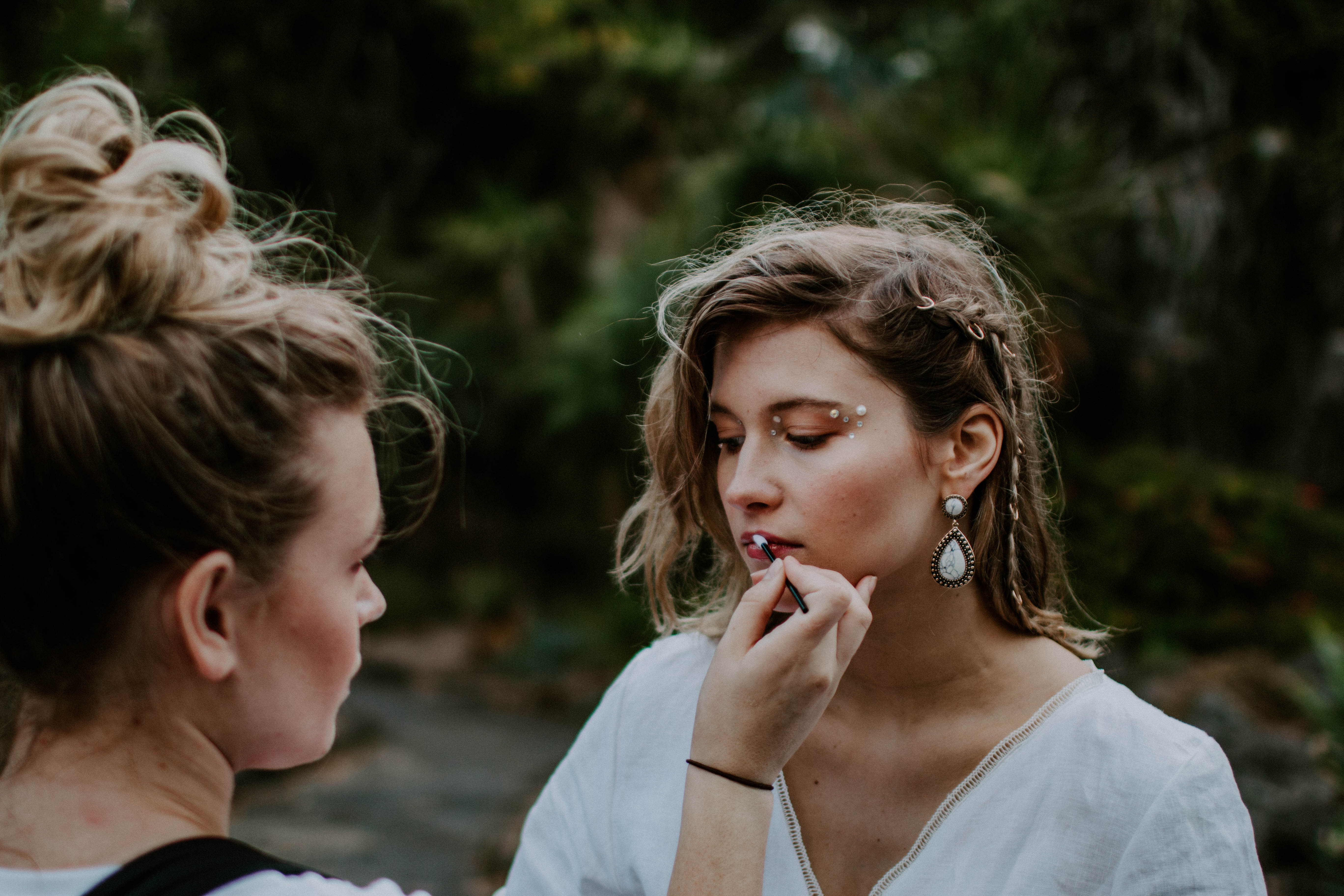 make-up artist applying make-up during styled photo shoot