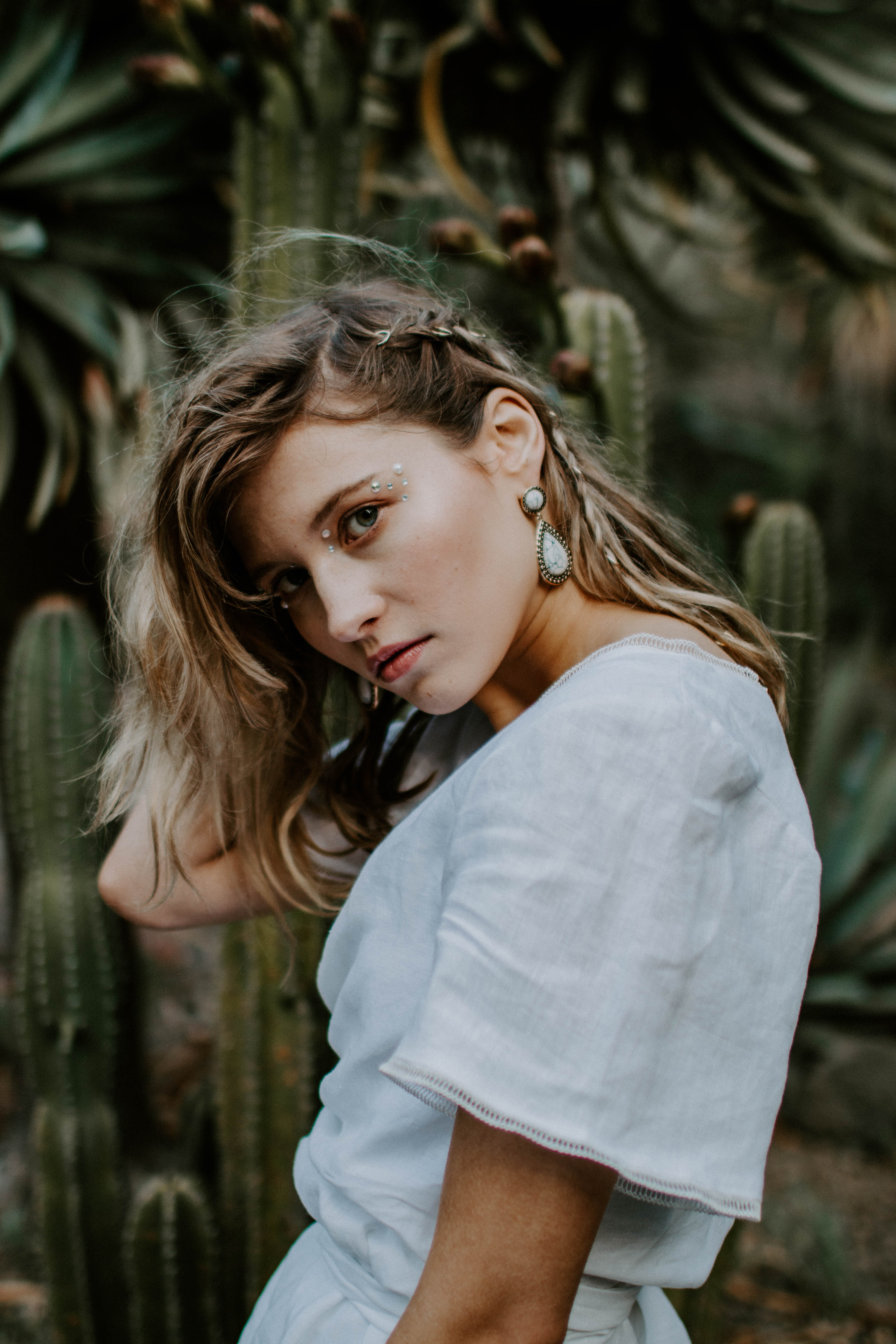 blonde girl wearing boho make-up and braids