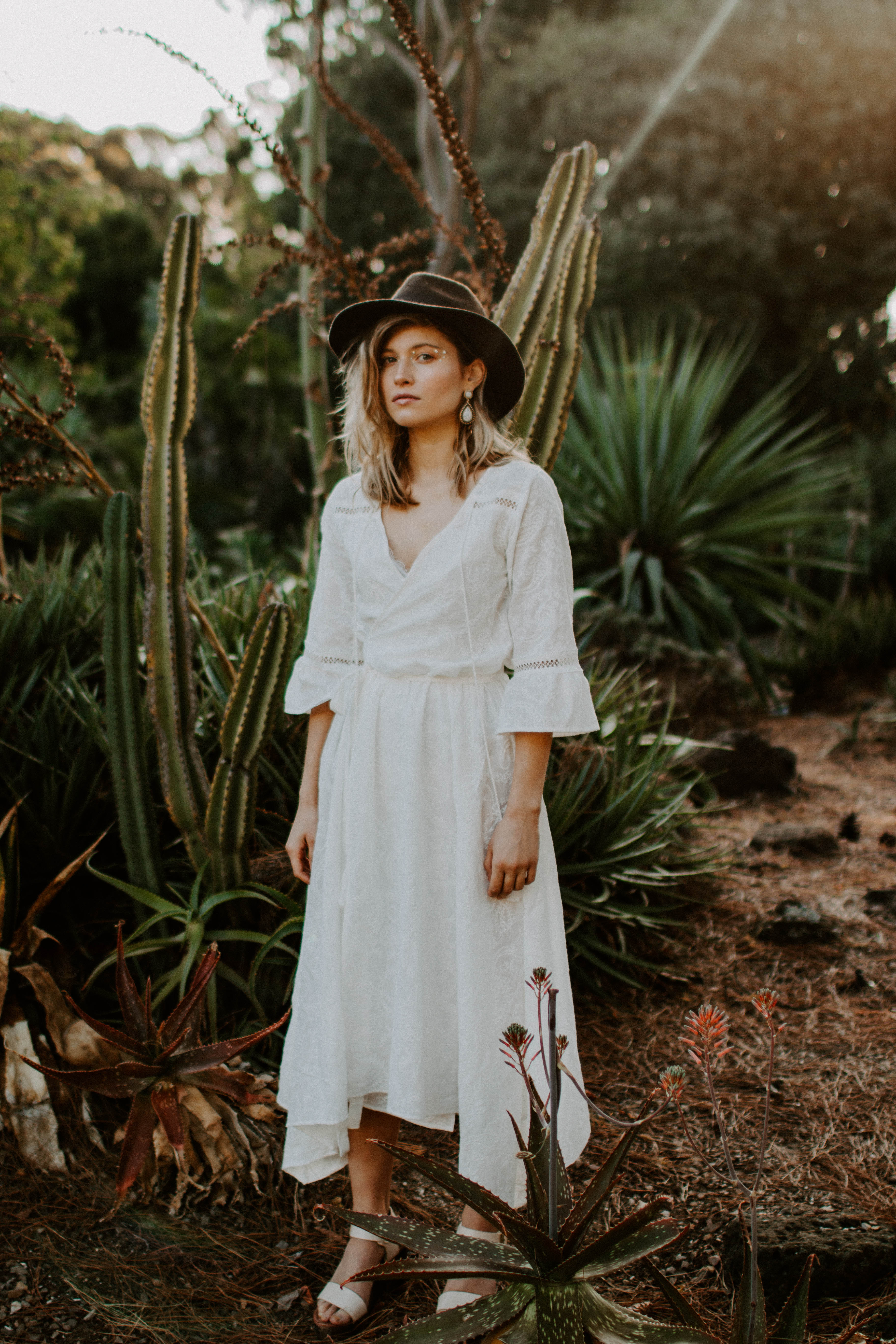 blonde girl model at a sunset in botanical garden